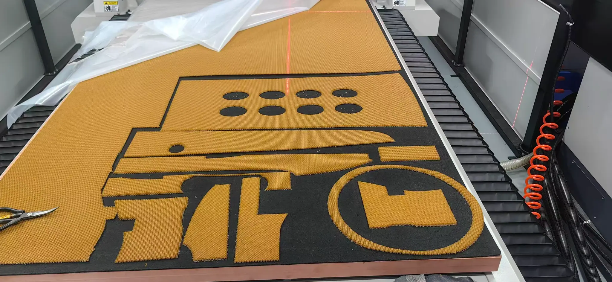Golden honeycomb composite panel being cut on a CNC machine